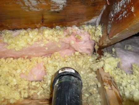 The plumbing vent likely contributed lots of moisture to this icy attic sheathing.
